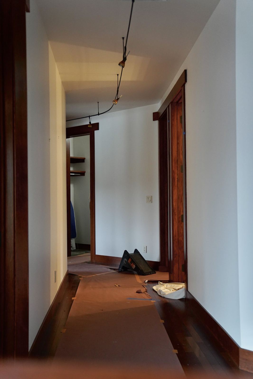 A finished hallway with clean walls and wood trim