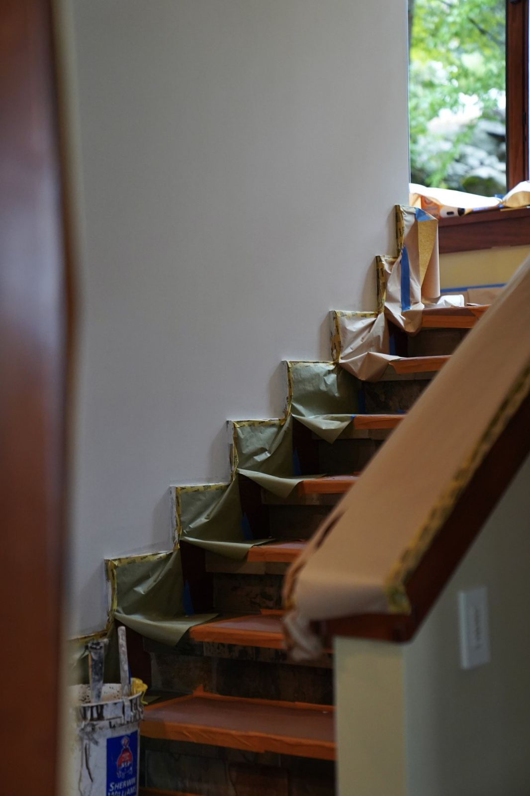 A staircase masked and protected before painting